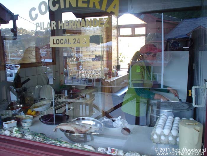 Looking throw the window of a small kitchen restaurant in Angelmó Chile