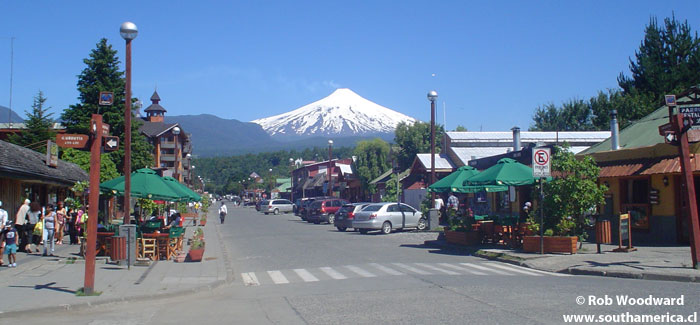 One of the streets of Pucón with the volcano in the background